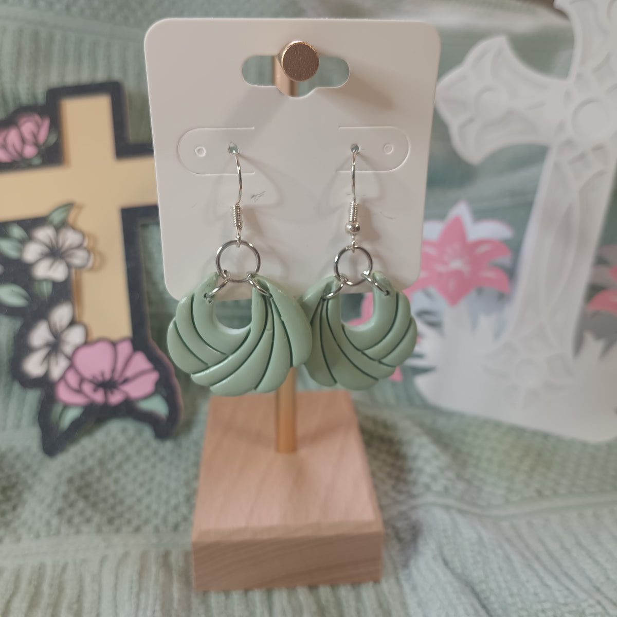 Sage green twisted knot clay hoop dangle earrings with silver hardware