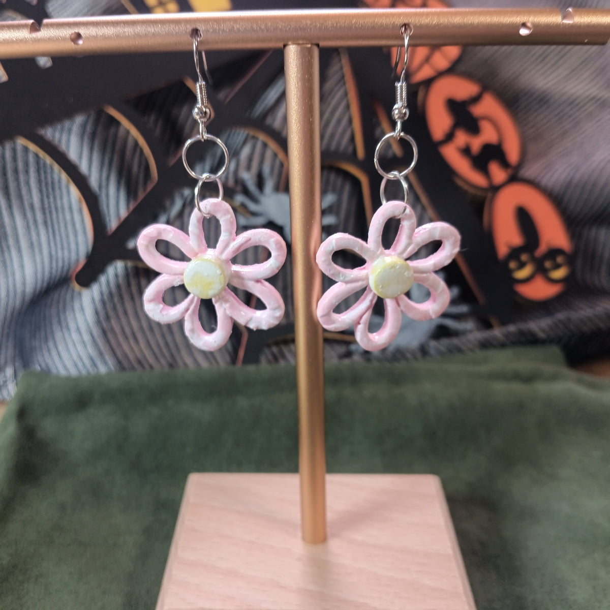 Blush pink open-petal daisy clay dangle earrings with yellow-green pearl center