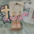 Soft pink twisted knot clay hoop dangle earrings with gold hardware