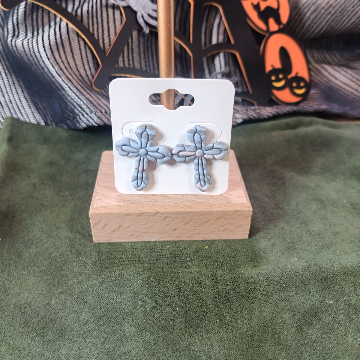 Slate blue ornate clay cross stud earrings with ribbed petal design